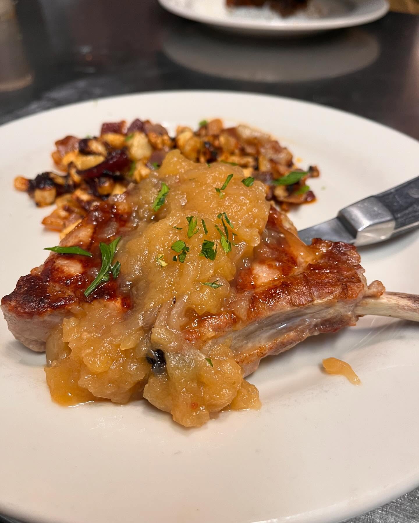 Signature pork chop with caramelized onions and nuts